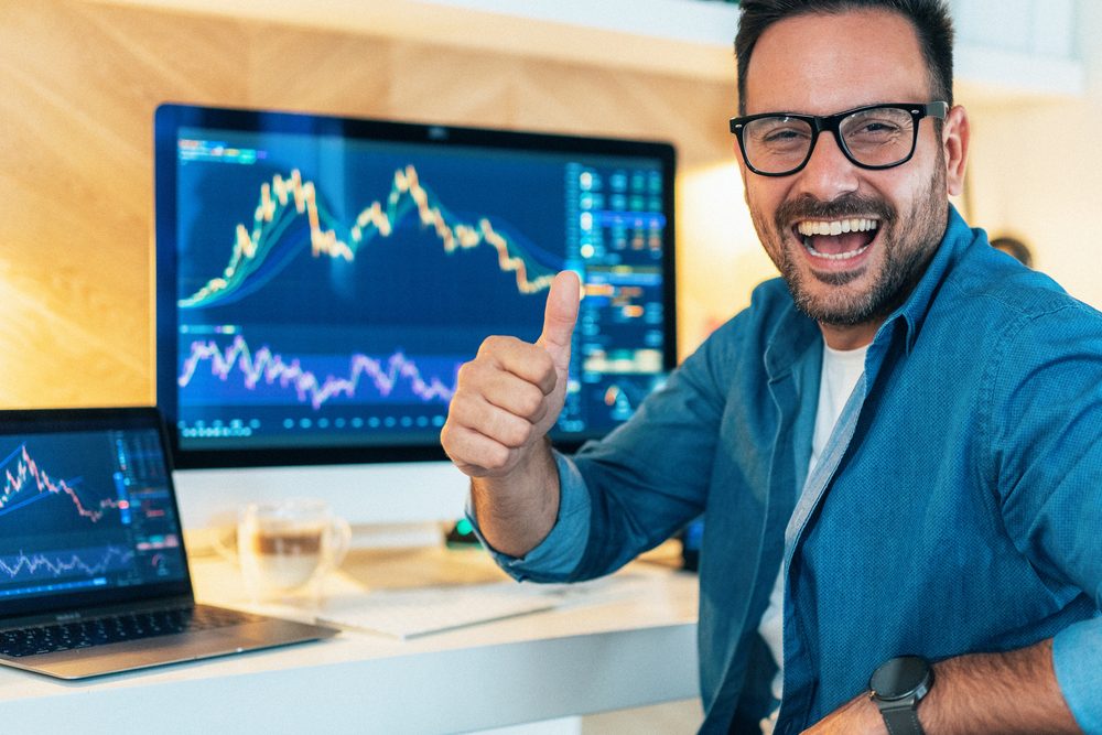 Trader pleased with a result at their desk